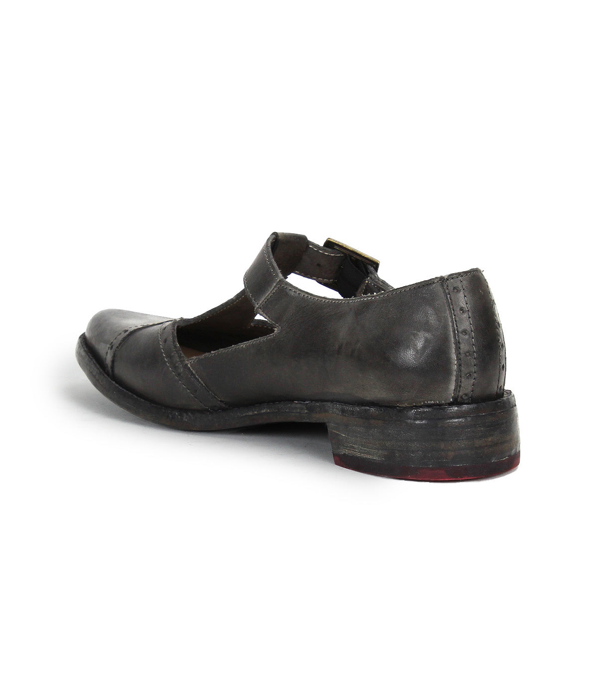 The Bed Stu Jenny is a dark gray leather Mary Jane casual shoe with a low heel, visible stitching, and an instep strap, featuring a cushioned insole for comfort. Shown from the back angle.