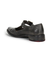 The Bed Stu Jenny is a dark gray leather Mary Jane casual shoe with a low heel, visible stitching, and an instep strap, featuring a cushioned insole for comfort. Shown from the back angle.