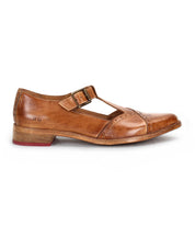 The Bed Stu Jenny is a brown leather Mary Jane with a T-strap, double buckle, pointed toe, cushioned insole, and low wooden heel, displayed in side profile against a white background.