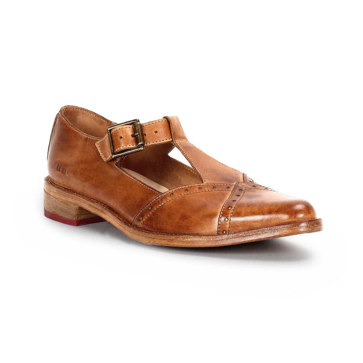The Bed Stu Jenny is a brown leather Mary Jane casual shoe with a T-strap pointed toe, buckle strap, low wooden heel, cushioned insole, and decorative stitching, shown on a white background.