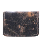 The Jeor card wallet by Bed Stu features rustic dark brown leather with visible scuffs, creases, two square imprints on the lower right corner, and multiple credit card slots for convenience.