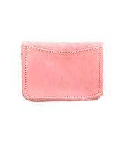 The Bed Stu Jeor is a small, rectangular card holder in light pink rustic leather with visible stitching and a single front pocket, shown against a white background.