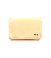 The Jeor card holder by Bed Stu is a small, rectangular beige rustic leather accessory featuring visible stitching and two square accents in the bottom right corner.