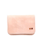 The Jeor by Bed Stu is a simple, light tan compact wallet with visible stitching and two small square accents in the lower right corner—an accessory that blends style and practicality.