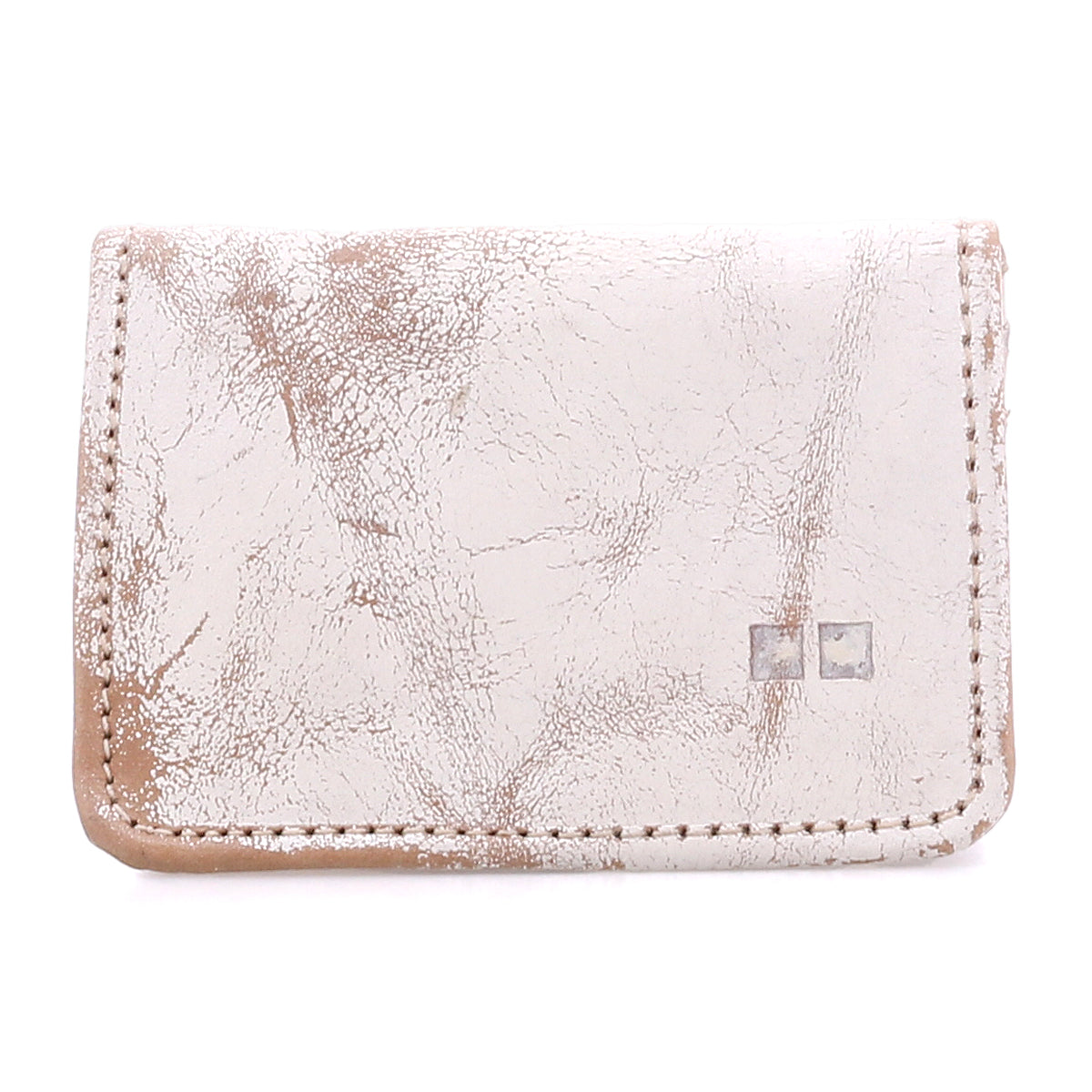The Bed Stu Jeor is a rustic, light-colored leather card wallet with visible creases, two metallic square accents on the front, and multiple slots for everyday credit card storage.