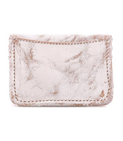 The Bed Stu Jeor is a small, rustic leather card wallet with visible creases and scuffs, featuring credit card slots and shown against a white background.