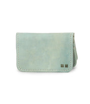 The Jeor by Bed Stu is a small, light blue rustic leather card holder wallet featuring visible stitching, two small square metal accents in the lower right corner, and multiple credit card slots.