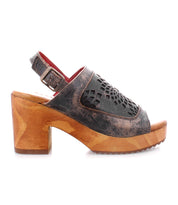 This women's Jinkie sandal by Bed Stu features an adjustable ankle buckle and a wooden platform, perfect for those looking for a stylish and comfortable heel option.