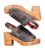 A pair of Bed Stu Jinkie women's sandals with adjustable ankle buckle and wooden heels.