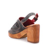 A pair of Bed Stu Jinkie women's clogs with a wooden heel and an adjustable ankle buckle.