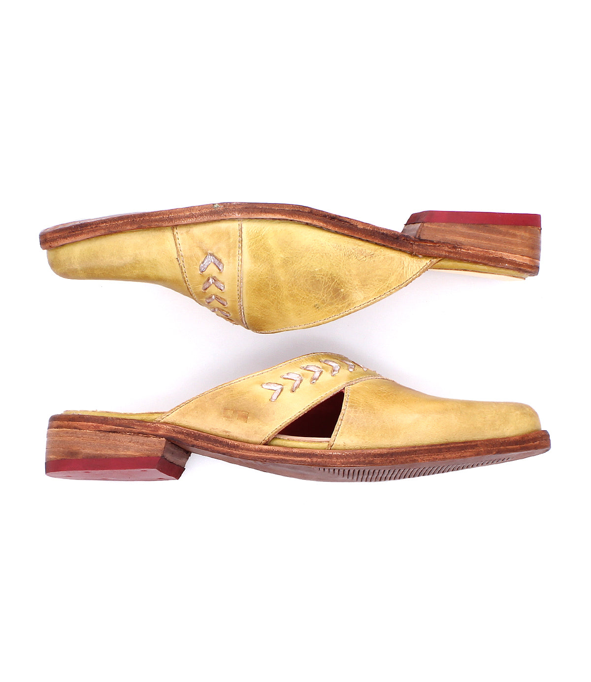 The Bed Stu Jockey slip-on shoes feature yellow leather, pointed toes, wooden soles, and red heel accents, shown side by side on a white background.