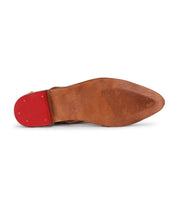 The underside of the Bed Stu Join dress shoe features a pointed toe, brown leather with handwoven arrow inlays, a red heel, and a textured grip forefoot.