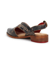 A back view of the Bed Stu Join sandal, featuring vintage-style leather, a wooden sole, heel strap with metal buckle, decorative stitching, and handwoven arrow inlays.
