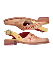 The Bed Stu Join is a tan and yellow leather slingback flat with pointed toes, red stitching, handwoven arrow inlays, low wooden heels, and metal buckles—shown here in a side view.