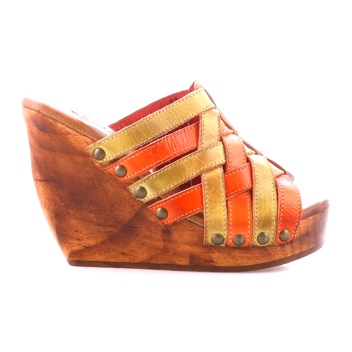 The Bed Stu Josie II is a brown wooden wedge sandal with orange and tan hand-woven leather straps and metal studs, shown on a white background.