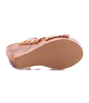 The image shows the bottom view of the Bed Stu Josie II wooden wedge sandal, featuring a smooth sole and decorative hand-woven leather straps along the sides.