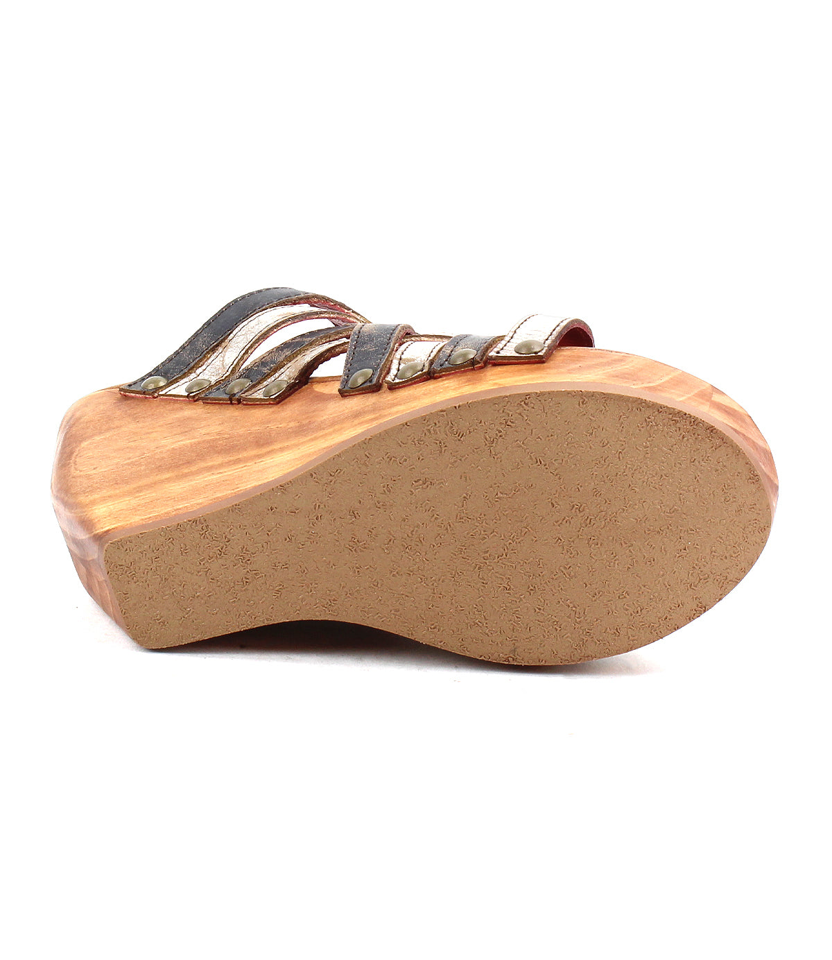 The Josie II by Bed Stu is a wooden wedge sandal with a light brown sole, black and metallic upper straps, and chic metal stud accents, shown from the bottom for added detail.