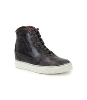 The "Joyce II" by Bed Stu is a black leather high-top sneaker featuring a lace-up front, contrasted with white soles and coordinated black laces, showcased from the side against a white background.