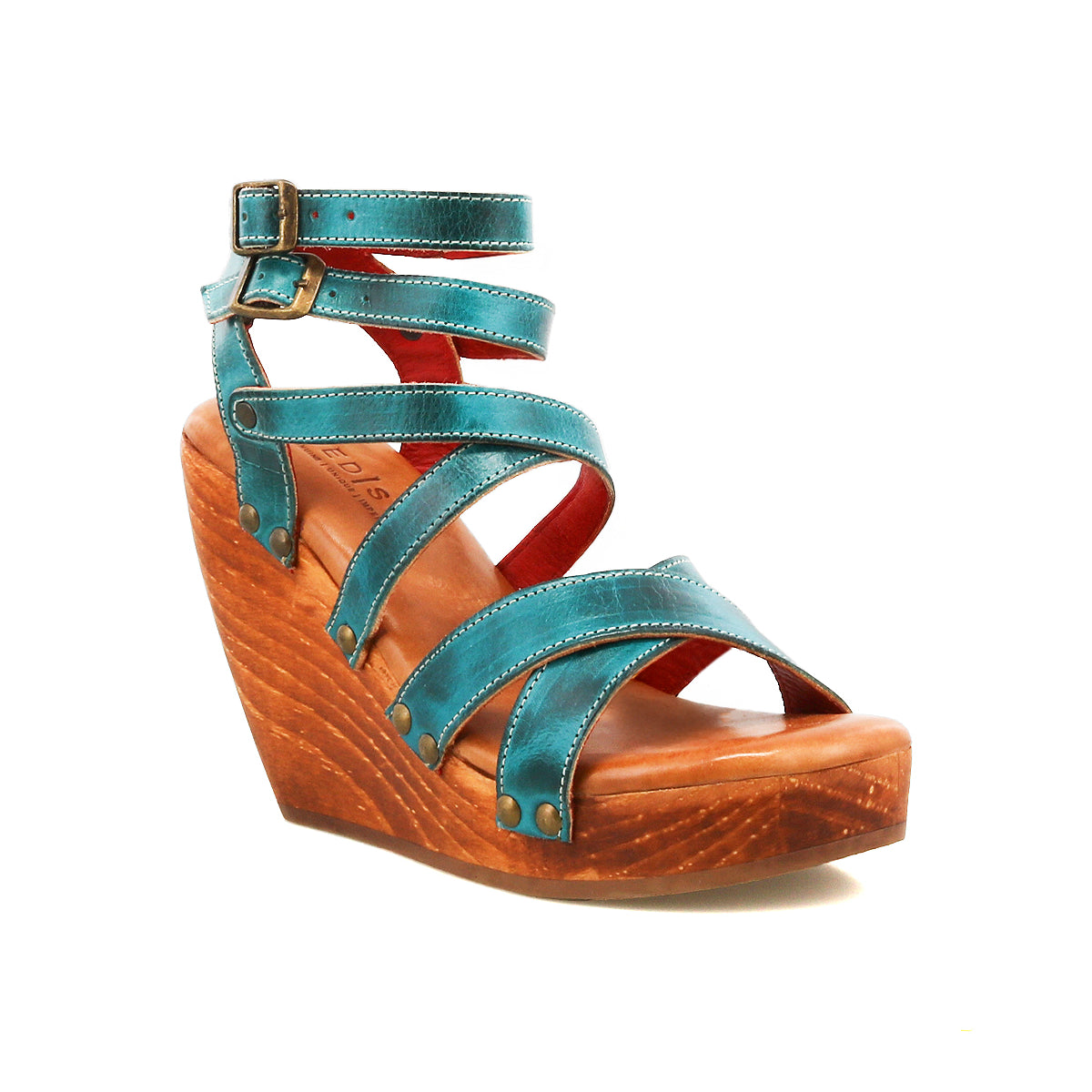 The Bed Stu Juliana II is a teal platform sandal with a strappy upper, ankle buckle, and sleek wooden wedge heel, shown on a white background.