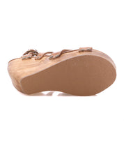 Side view of the Juliana II wooden wedge sandal by Bed Stu, showcasing a rubber sole, leather straps, and a studded upper.
