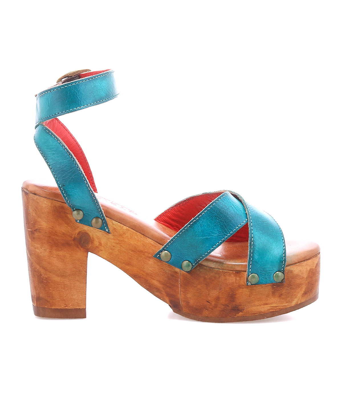 The Bed Stu Kalah is a women's platform sandal featuring sustainably sourced wooden heels, teal leather crisscross straps, and an adjustable ankle strap with buckle.