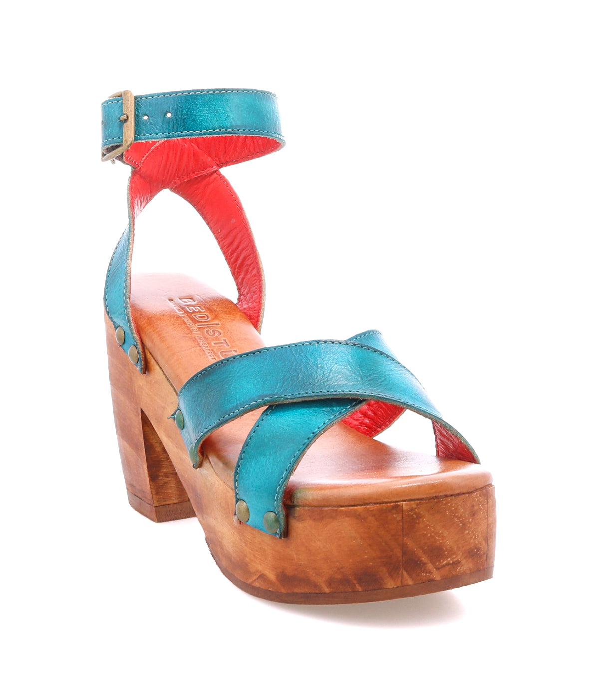 The Kalah sandal by Bed Stu features a teal and red design, sustainably sourced wooden platform heel, open toe, adjustable ankle strap, and buckle closure.