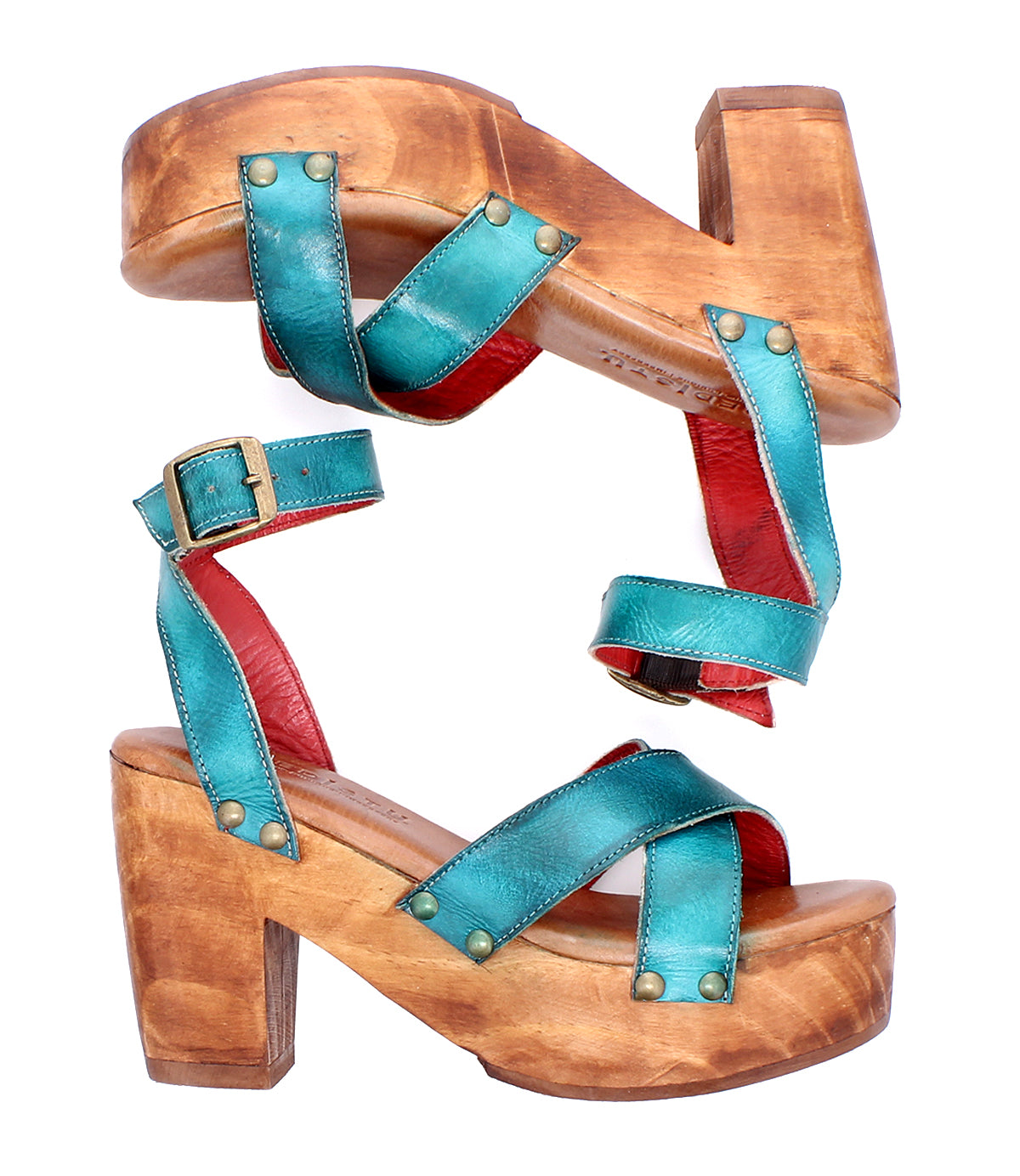The Bed Stu Kalah sandals feature teal leather straps, a sustainably sourced wooden heel, brass studs, adjustable buckle closures, and an ankle strap—all showcased against a white background.