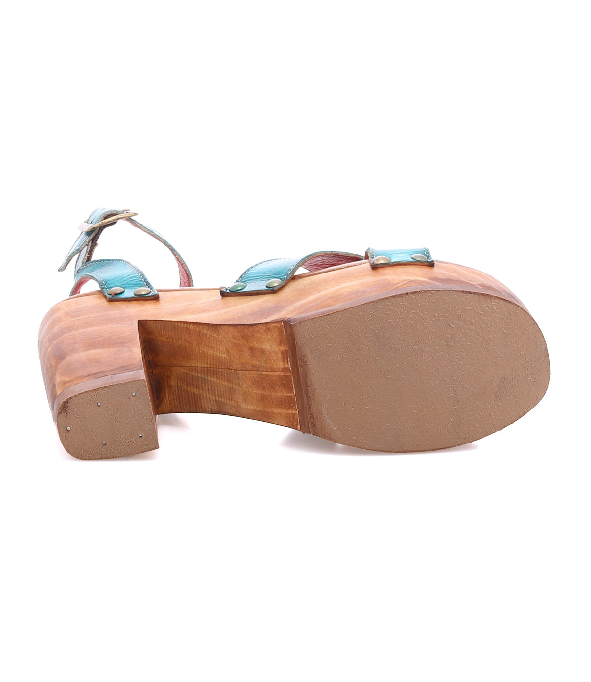 The Bed Stu Kalah is a wooden platform sandal featuring a chunky, sustainably sourced wooden heel, blue straps, and a rubber sole, shown from the bottom.