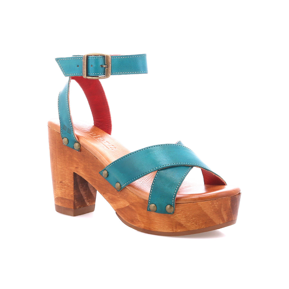 The Bed Stu Kalah is a teal leather sandal with an ankle strap, buckle, crisscross toe design with metal rivets, and a sustainably sourced wooden platform heel, shown against a white background.