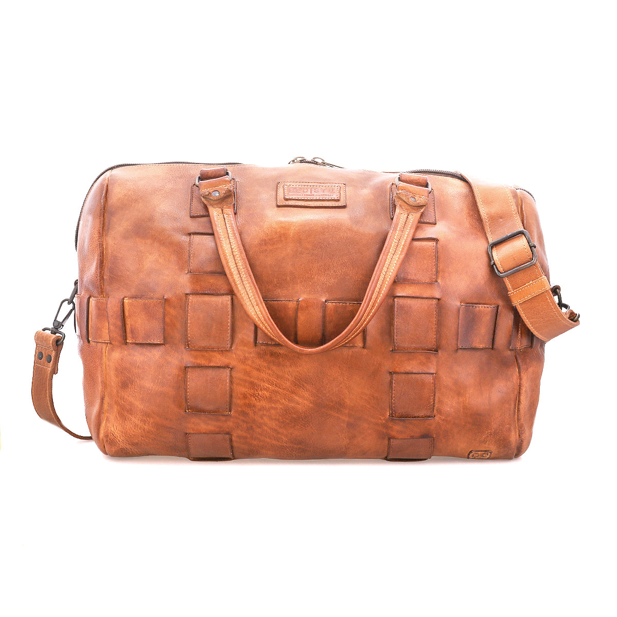 The Bed Stu Keg is a brown duffle bag made from vegetable tanned leather, with two handles, an adjustable shoulder strap, a luggage sleeve, and square patchwork details on the front.