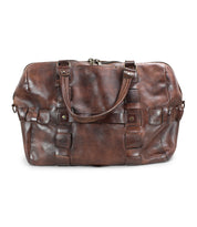 A handcrafted brown leather travel duffel bag with double handles and a zipper closure, made from vegetable tanned leather. The Keg by Bed Stu.