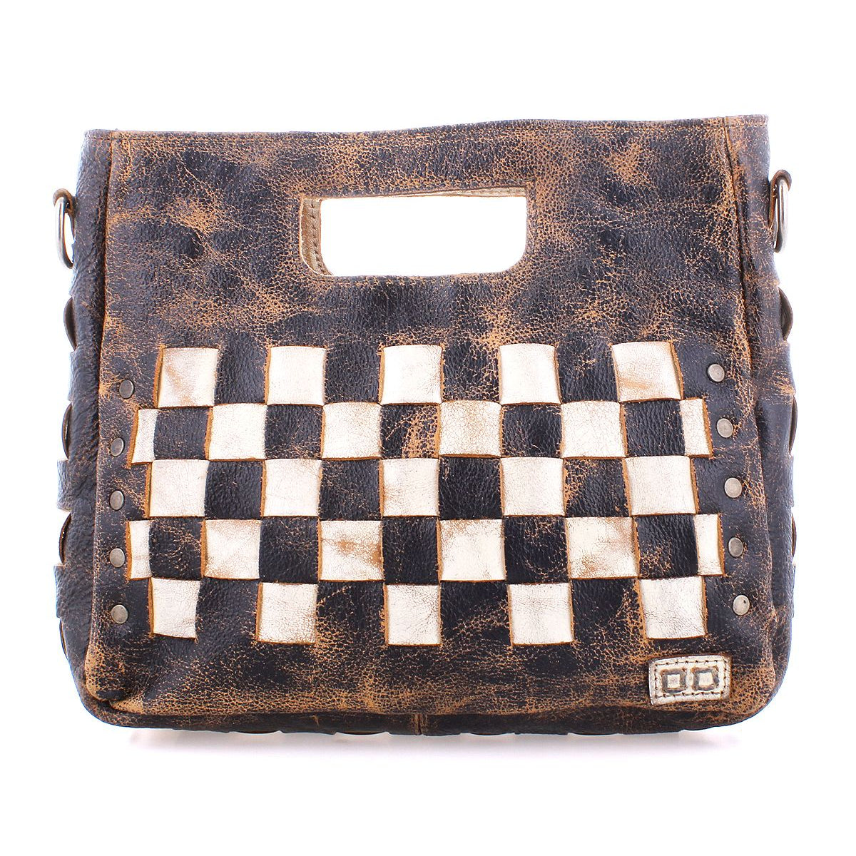 The Keiki bag by Bed Stu is a brown leather accessory featuring a built-in handle and a striking black and white checkerboard pattern on the front. It boasts a weathered, rustic look complemented by metallic rivet details. The adjustable strap allows for versatile crossbody wear, and the zip-top closure ensures added security.