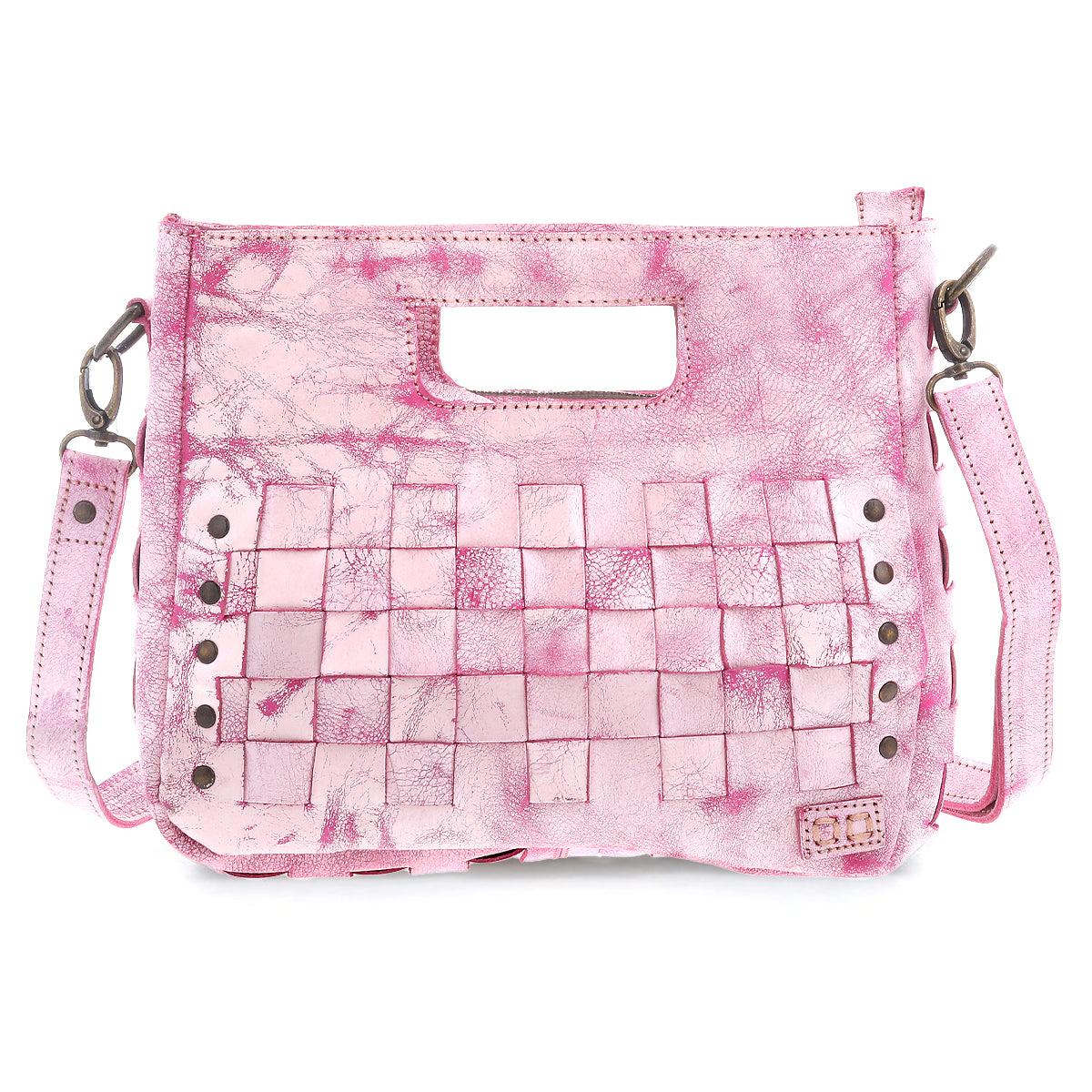 The Keiki by Bed Stu is a pink leather handbag with a textured finish, cutout handle, and woven panels. Adorned with studs, it features an adjustable shoulder strap for crossbody wear and a zip-top closure for security.