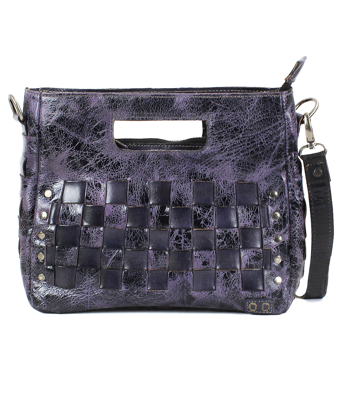 The Keiki by Bed Stu is a purple textured leather crossbody bag featuring front woven panels, metal studs, and a detachable, adjustable strap.