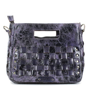 The Bed Stu Keiki is a black and purple textured leather crossbody bag featuring woven front panels, an adjustable strap, a cut-out handle, and metal studs along the lower sides.