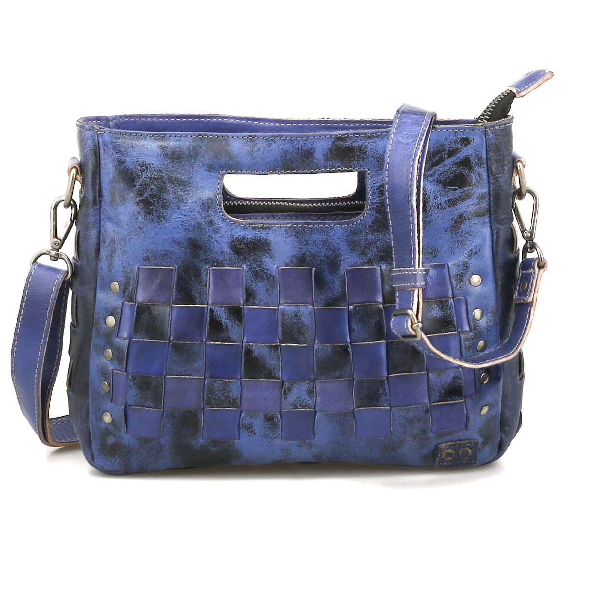 The Keiki by Bed Stu is a compact blue leather handbag with woven checkerboard panels, metal studs, a detachable shoulder strap for crossbody use, and a chic cutout handle.