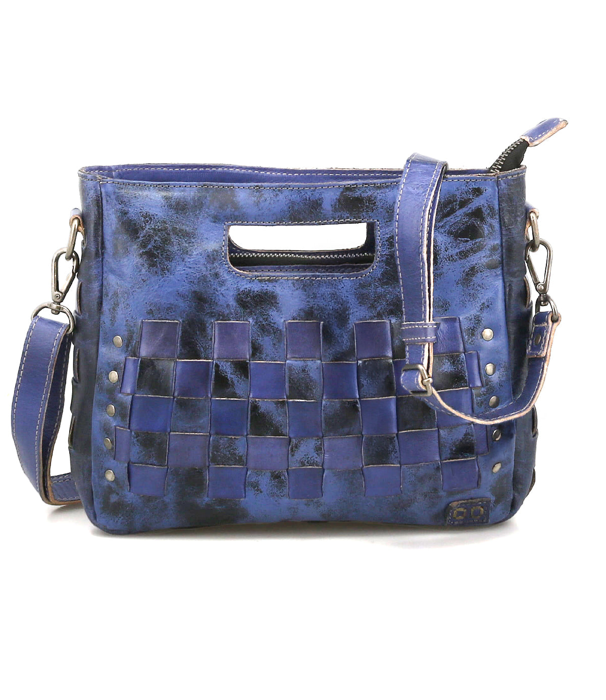 The Keiki by Bed Stu is a compact blue leather handbag with woven checkerboard panels, metal studs, a detachable shoulder strap for crossbody use, and a chic cutout handle.