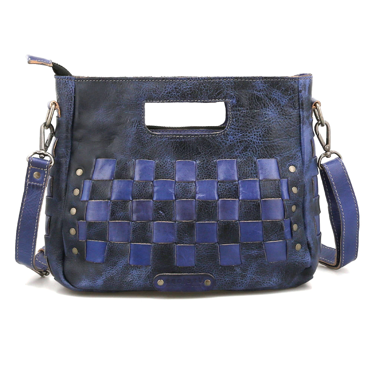 The Keiki by Bed Stu is a blue leather crossbody bag with woven square panels, metal studs, a cutout handle, and a detachable shoulder strap—an ideal compact accessory for everyday style.