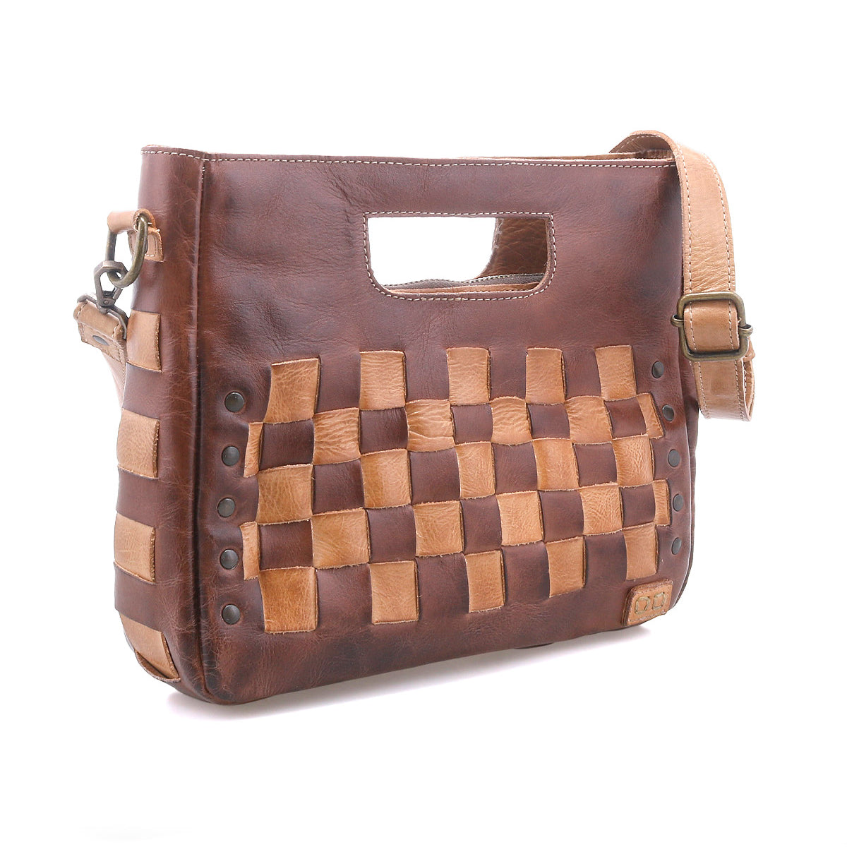 The Bed Stu Keiki is a brown leather woven checkerboard bag with an adjustable strap, built-in handle, and metal rivet details. This compact crossbody makes a graphic statement and elevates any outfit.