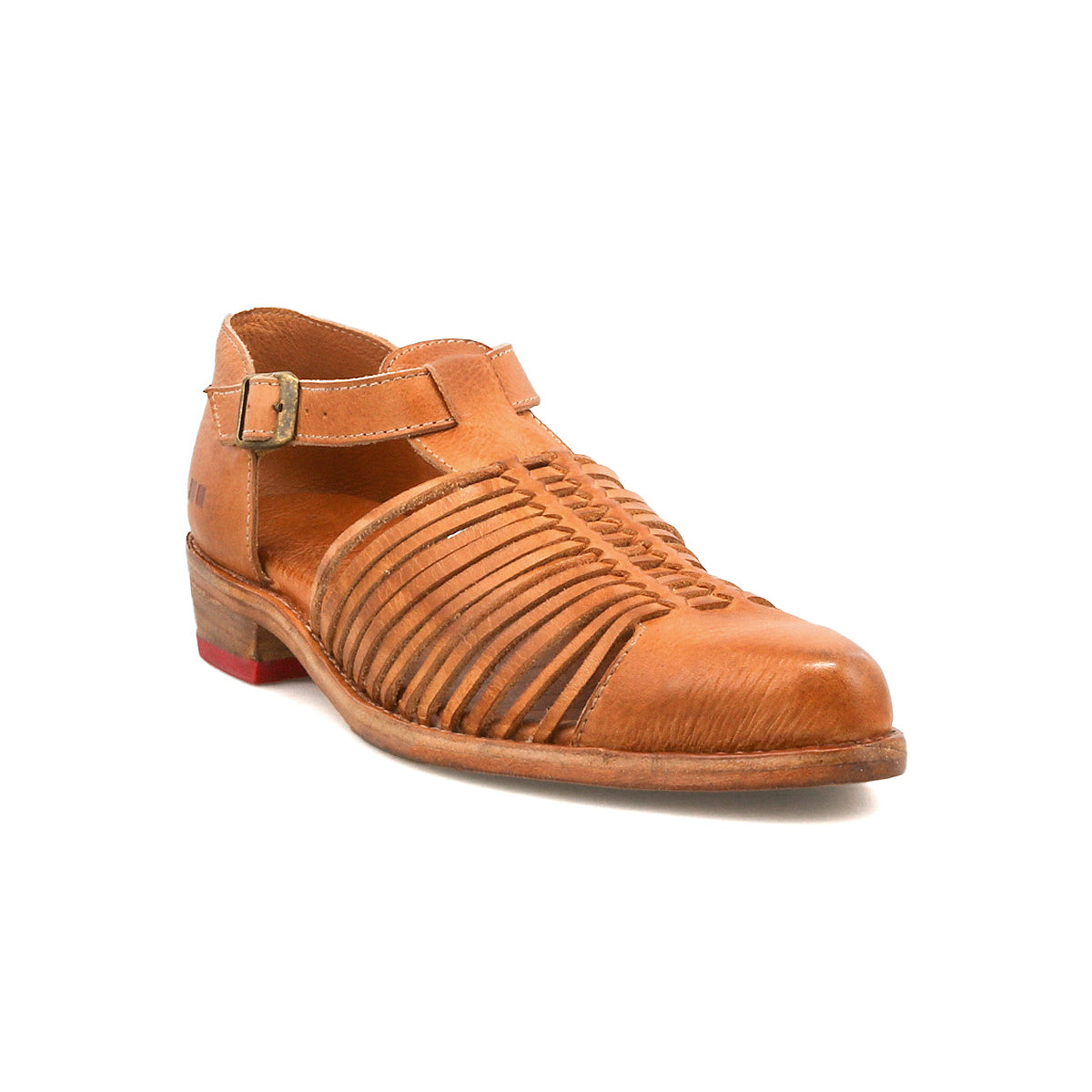 The Bed Stu Kenna is a brown leather sandal with a closed toe, woven cutouts, an adjustable ankle strap, low heel, and a small red accent on the back.