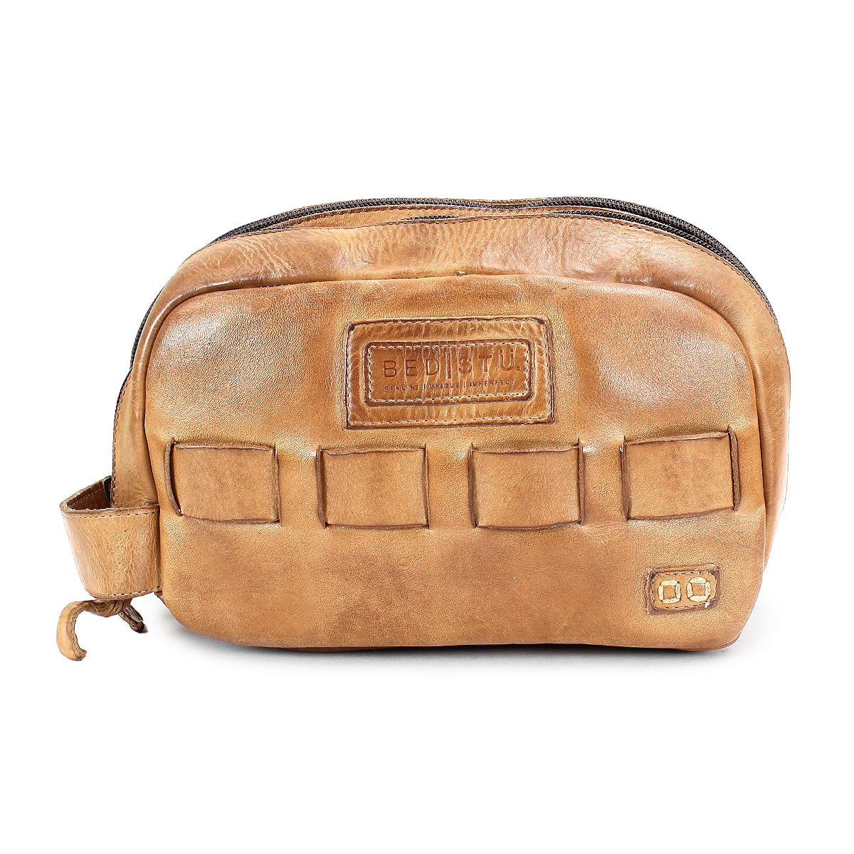 A brown leather dopp kit called Kip with a zipper closure, multiple exterior pockets, and a small handle on the side. This travel essential from Bed Stu is made of vegetable tanned leather for durability and style.