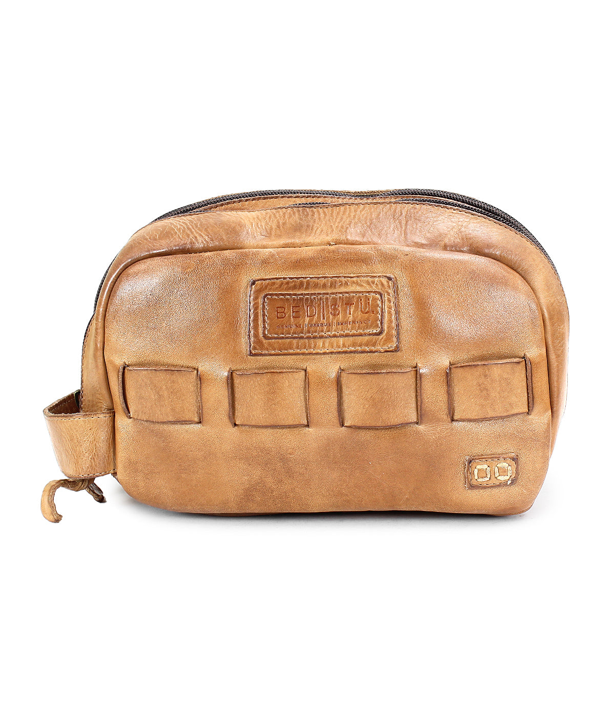 A brown leather dopp kit called Kip with a zipper closure, multiple exterior pockets, and a small handle on the side. This travel essential from Bed Stu is made of vegetable tanned leather for durability and style.