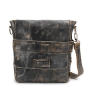 A distressed, handmade leather messenger bag with a front flap, horizontal strap detail, and adjustable shoulder strap. The bag boasts a worn, vintage appearance and an organic cotton-lined interior. Labeled "Bed Stu" on the front pocket, the Kure features vegetable tanned leather for durability.
