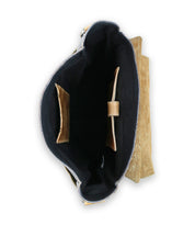 Top view of an open handmade leather messenger bag, Bed Stu Kure, displaying a spacious interior with dark, organic cotton lining, a central compartment, and multiple pockets.