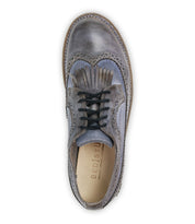 Top view of a gray leather brogue shoe with black laces, decorative perforations, and a subtle wingtip toe design, featuring the brand name "Bed Stu" on the insole. This product is known as Lita K - Archived.