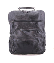 The Bed Stu Lafe backpack, crafted in black leather with a top handle, features two zippered front pockets and a discreet security tab. Set against a plain white background, it combines style and functionality with its spacious design.