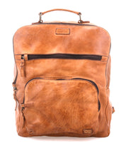The Bed Stu Lafe is a spacious tan leather backpack featuring a top handle, front zip pocket, and branded label—an ideal choice for a stylish travel carry-on.