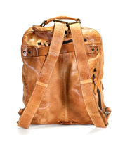 The Lafe backpack by Bed Stu, shown from the back, is a spacious tan leather bag featuring adjustable straps, multiple pockets, and a security tab.