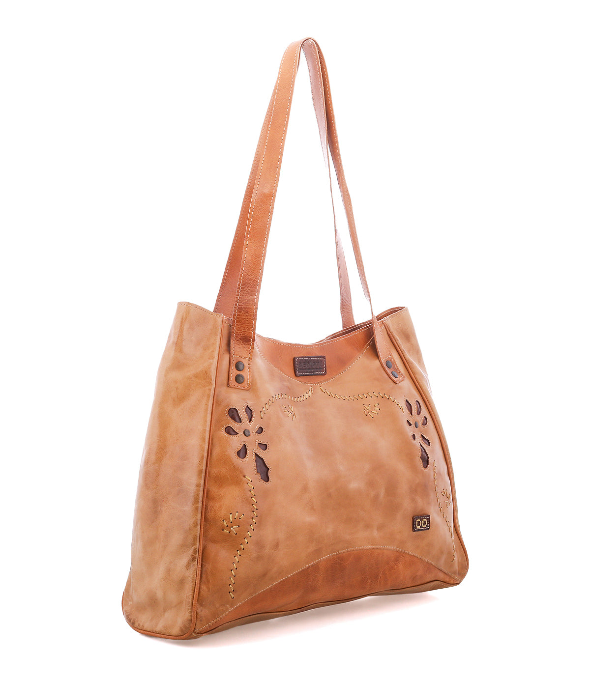 The Bed|Stü Larue LTC is a tan leather shoulder bag with decorative cutouts, metal studs, and double straps, shown on a white background.
