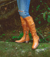 A woman wearing Leilani tan leather over the knee boots by Bed Stu.